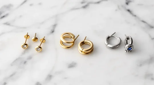 Artistic arrangement of asymmetric earrings creating a cohesive ear curation look