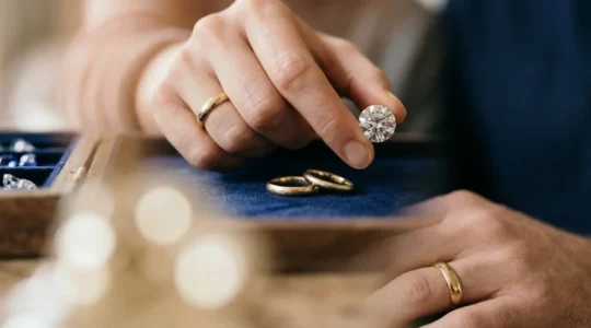 Couple examining precious gemstones in an elegant jewelry box for their tenth wedding anniversary