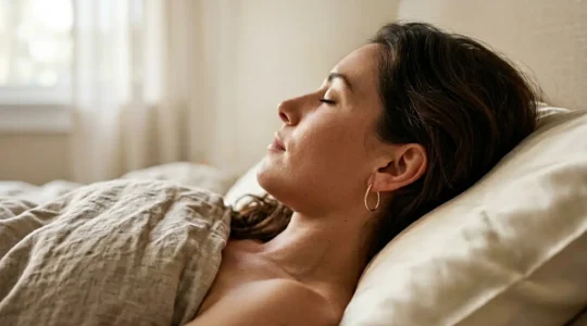 Woman sleeping peacefully on side with elegant single loop earrings