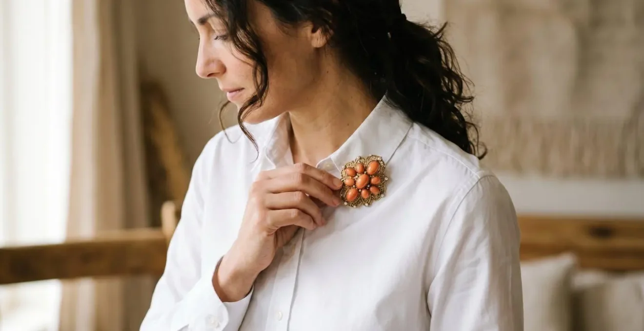 Vintage coral brooch styled in contemporary fashion contexts